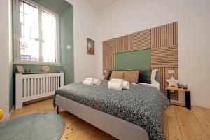 a bedroom with a bed with towels on it at Gazometro Apartment SelfCheck-in in Rome
