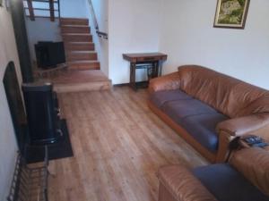 a living room with a couch and a television at Shangri-La in Villar Pellice