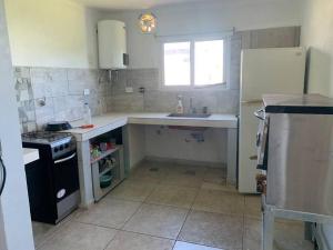 a small kitchen with a sink and a refrigerator at 4 personas en paz in Mar del Plata