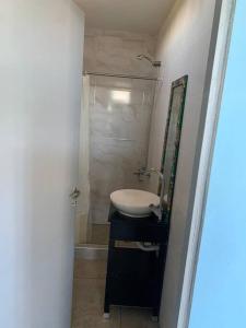 a bathroom with a sink and a shower at 4 personas en paz in Mar del Plata