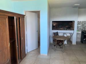 a room with a table and a room with a kitchen at 4 personas en paz in Mar del Plata