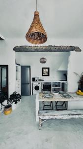 a white kitchen with a table and a counter top at Sol living in Tinos