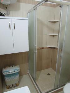 a shower with a glass door in a bathroom at Aati Apartment in Durrës
