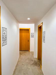 a hallway with two doors and posters on the wall at ام ريزيدنس M Residence in Abha