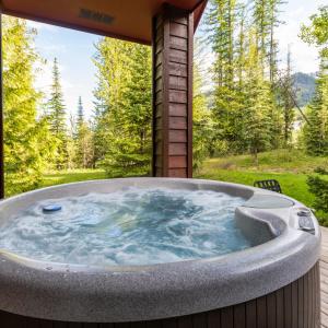 a jacuzzi tub in the backyard of a house at Polar Peak by Fernie Central Reservations in Fernie