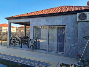 a house with a patio and a swimming pool at Lotus Guesthouse in Fatʼmayy