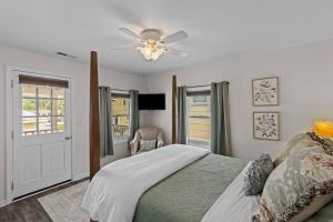 a bedroom with a bed and a ceiling fan at Sunshine Cottage in New Bern