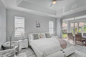 een witte slaapkamer met een bed en een badkamer bij Glamour House in Wellington