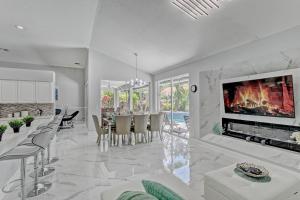 a living room with a fireplace and a dining room at Glamour House in Wellington