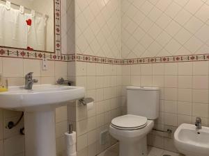 a bathroom with a toilet and a sink at Discovery Apartment Benfica in Lisbon +45 photos