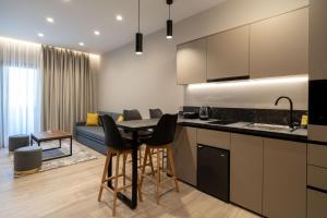 eine Küche und ein Wohnzimmer mit einem Tisch und Stühlen in der Unterkunft d Suites and Apartments in Ioannina