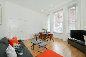 a living room with a couch and a table at London Choice Apartments - Gloucester Road - Kensington in London