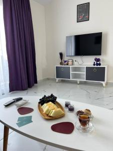 a living room with a table with food on it at ArtLife apartments FIGA с видом на море in Alanya