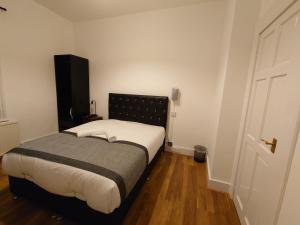 a small bedroom with a bed and a door at Centra Hemel in Hemel Hempstead
