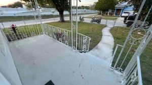 an open gate on a swing set on a street at Our Nest - Historic Ybor City in Tampa