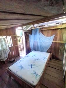 a bed in a room with a mosquito net at Hostal Atrapasueños playa La Barra in Buenaventura