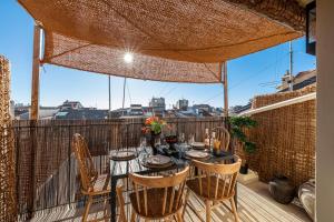 a patio with a table and chairs on a balcony at WABISABI SUITES - MÉRO in Cannes