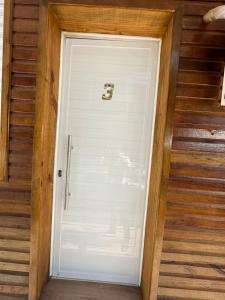 a white door in a room with stairs at Loft Lux 3 in Chapecó