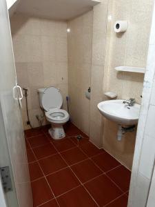 a bathroom with a toilet and a sink at Everest Restaurant and Guest House in Sihanoukville