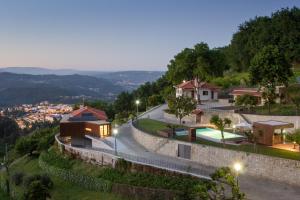 a house on top of a hill with a street at Quinta do Fontelo in Vouzela