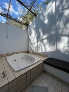 a bath tub in a room with a window at Mama Chuy Hotel & Villas in San Juan Cosalá