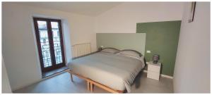 um pequeno quarto com uma cama e uma janela em Da Titti Appartamento Assisi em Assis