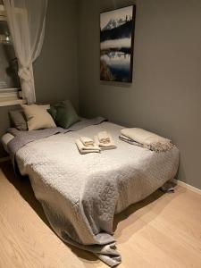 a bedroom with a bed with two towels on it at Cosy and centrally located apartment in Tromsø