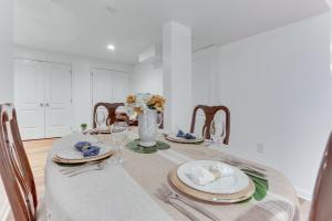 a dining room with a table with plates and napkins at Cozy Inwood Apartment History, Hiking and Wine! in Inwood