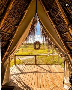 a view from the inside of a tent with a wreath at Flor da Aldeia Eco Hospedaria in Camaçari