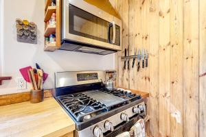 a kitchen with a stove and a microwave at Hearthwood in Fort Bragg