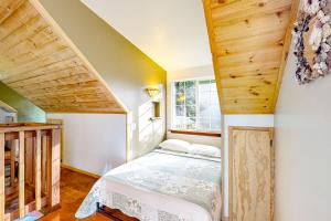 a small bedroom with a bed and a window at Hearthwood in Fort Bragg