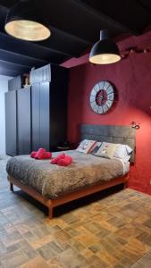 a bedroom with a large bed with a red wall at Estudi Suite Desvern in Sant Just Desvern