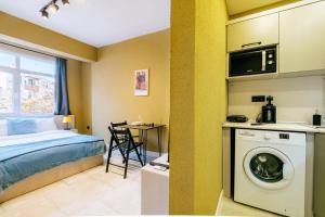 a bedroom with a bed and a washing machine at Studio Flat 6 min to Yedikule Fortress in Fatih in Istanbul