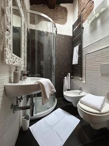 a bathroom with a sink and a toilet at CasaMancio, loft in heart of medieval Tuscan city in Pistoia