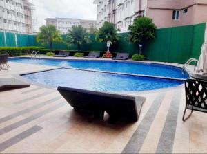 a large swimming pool in the middle of a building at Staycation at Cheers Residences in Lias