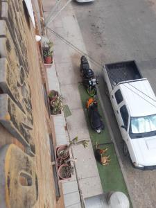 a white car parked on the side of a street at hostal consulado in Caldera