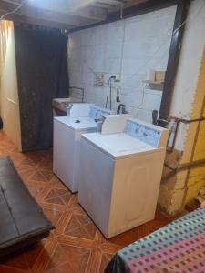 a room with two washing machines and a sink at hostal consulado in Caldera