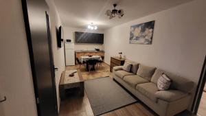 a living room with a couch and a table at Casa 115 Toplița in Topliţa