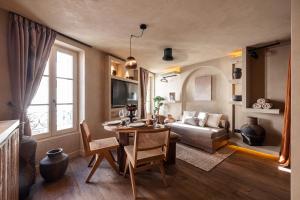 a living room with a table and a couch at WABISABI SUITES - MÉRO in Cannes