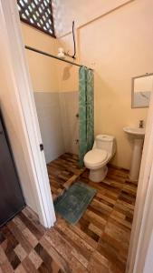 uma casa de banho com um WC e um chuveiro em Apartamentos Sol em Cahuita