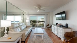a living room with a couch and a table at Oceanfront spectacular views with direct beach and pool access! in Ormond Beach