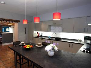 a kitchen with a table with fruits and flowers on it at 1 bed in Bala 52510 in Corwen