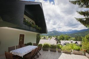 a table on a patio with a view of mountains at Villa Bohinj in Bohinj