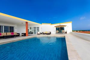 a swimming pool in the backyard of a house at Lovely 4-Bed Villa in Anguilla in Long Path