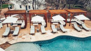 an overhead view of a pool with chairs and umbrellas at Camp Hideaway Gruene in New Braunfels