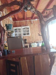 a wooden table in a room with a tree at CABAÑA NELTUME MAGLENE ITURRA in Panguipulli