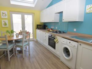 a kitchen with a table and a washing machine at 3 bed in Eastbourne EHC04 in Eastbourne