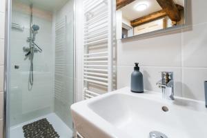 a bathroom with a white sink and a shower at Horský apartmán Temari 15 Klínovec in Loučná pod Klínovcem +43 photos