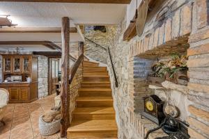 a staircase in a room with a brick wall at Casa Gianni in Plomin