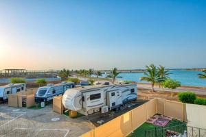 a group of rvs parked in a parking lot at منتجع شاطئ الورد in Yanbu